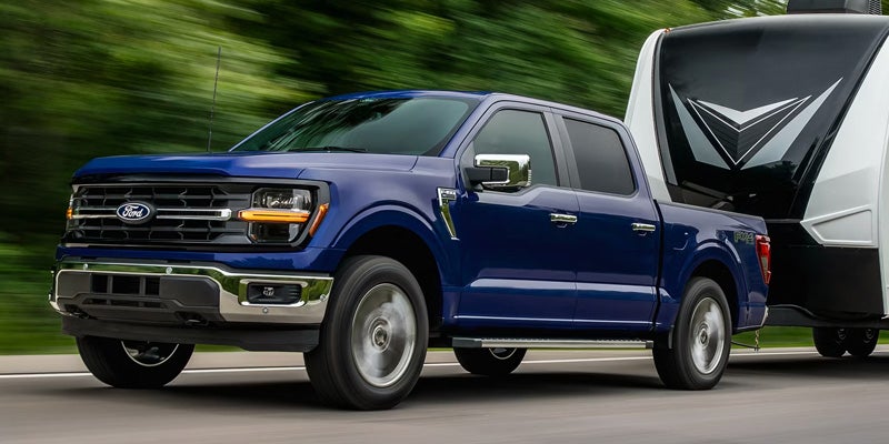 Blue Ford F-150 cruising on highway